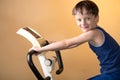 The child is trained on a stationary bike . Healthy lifestyle. Royalty Free Stock Photo