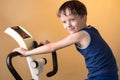 The child is trained on a stationary bike . Healthy lifestyle. Royalty Free Stock Photo