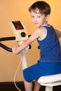 The child is trained on a stationary bike . Healthy lifestyle. Royalty Free Stock Photo