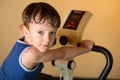 The child is trained on a stationary bike . Healthy lifestyle. Royalty Free Stock Photo