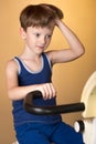 The child is trained on a stationary bike . Healthy lifestyle. Royalty Free Stock Photo