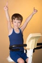The child is trained on a stationary bike . Healthy lifestyle. Royalty Free Stock Photo