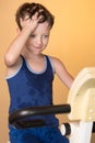 The child is trained on a stationary bike . Healthy lifestyle. Royalty Free Stock Photo