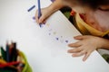 A child in training at home during quarantine makes origami out of paper. children`s creativity. hands close up Royalty Free Stock Photo