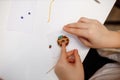 A child in training at home during quarantine makes origami out of paper. children`s creativity. hands close up Royalty Free Stock Photo