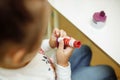 A child in training at home during quarantine makes origami out of paper. children`s creativity. hands close up Royalty Free Stock Photo