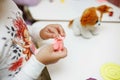 A child in training at home during quarantine makes origami out of paper. children`s creativity. hands close up Royalty Free Stock Photo