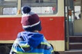 Child at tram stop