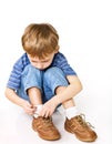 Child try to tie shoelaces Royalty Free Stock Photo