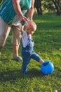 Child trying play in soccer or football.