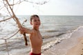 Child with tumbleweed plant on beach of Azov sea Royalty Free Stock Photo