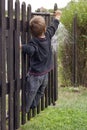 Child turning garden water tap Royalty Free Stock Photo