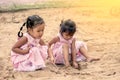 Child two asian little girls playing with sand in playground Royalty Free Stock Photo