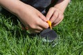 Child tying shoes on green grass,learn a boy to tie the laces in the sneakers on the grass Royalty Free Stock Photo