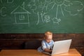 Child type weblog article in laptop computer. Little blogger keep weblog on school website