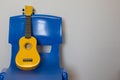 Child ukulele on chair. School music lesson practice room Royalty Free Stock Photo