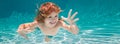 Child underwater. Funny face portrait of child boy swimming and diving underwater with fun in pool. Banner for header Royalty Free Stock Photo