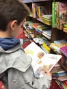 Child with unfold book in a bookstore Royalty Free Stock Photo