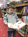 Child with unfold book in a bookstore