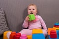 Child up to a year playing in cubes, laughs