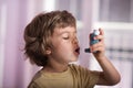 Child using asthma inhaler