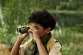 Child using binoculars outdoors in the forest Royalty Free Stock Photo