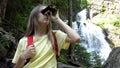 Child Using Binoculars by Waterfall in Mountains, Girl Hiking at Camping, Alpine Trails, Kid Traveling in Adventure Trip Vacation Royalty Free Stock Photo