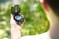 Child using a compass for navigation by a lake Royalty Free Stock Photo