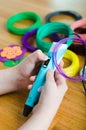 Child using 3D pen with colored ABS plastic. Creative hobby at home, technology, leisure, education concept Royalty Free Stock Photo