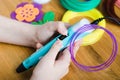 Child using 3D pen with colored ABS plastic. Creative hobby at home, technology, leisure, education concept Royalty Free Stock Photo