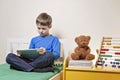 Child using digital tablet computer at home Royalty Free Stock Photo