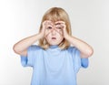 Child using fingers as binaculars Royalty Free Stock Photo