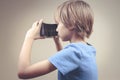 Child using new black 3D Virtual Reality cardboard glasses Royalty Free Stock Photo