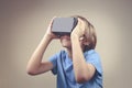 Child using new Virtual Reality, VR cardboard glasses Royalty Free Stock Photo