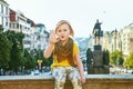 Child on Vaclavske namesti in Prague Czech Republic handwaving