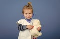 Child veterinarian smile with teddy bear on blue background