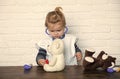 Child veterinarian with stethoscope examine toy animals