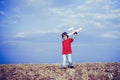 Child in the village with plane in his hands. Retro style airplane on nature background. Child boy toddler playing with Royalty Free Stock Photo