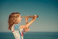 Child with vintage spyglass on summer vacation Royalty Free Stock Photo