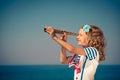 Child with vintage spyglass on summer vacation