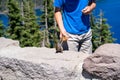 Child visiting Crater Lake National Park feeds a squirrel, in Oregon