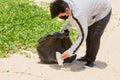 Child volunteer collecting garbage on beautiful beach at Karon Beach