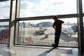 Child waiting for boarding plane at airport Royalty Free Stock Photo