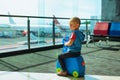 Child waiting for boarding to flight in airport transit hall Royalty Free Stock Photo