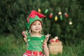 Child waiting for a Christmas in wood in juli. portrait of little children near christmas tree. girl decorating christmas tree Royalty Free Stock Photo