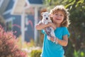 Child walk with a dog outdoor. Cute kid hug puppy.