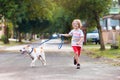 Child walking dog. Kids and puppy. Boy and pet Royalty Free Stock Photo