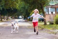Child walking dog. Kids and puppy. Boy and pet Royalty Free Stock Photo