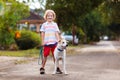 Child walking dog. Kids and puppy. Boy and pet Royalty Free Stock Photo