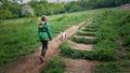 Child walking a dog though a wooded meadow Devon uk Royalty Free Stock Photo